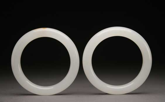 Appraisal: PAIR WHITE JADE BRACELETS Pair of Chinese carved light whitish-celadon