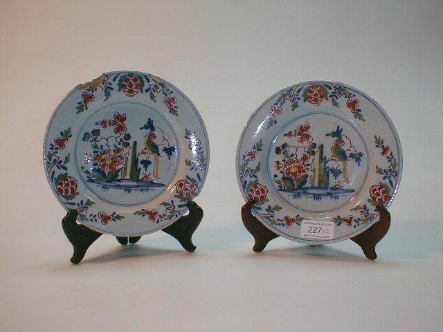 Appraisal: A pair of Delft plates polychrome painted with a parrot