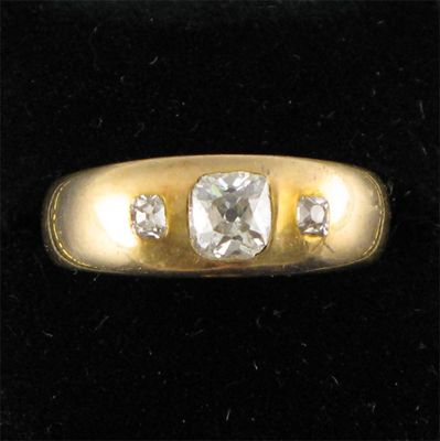 Appraisal: A diamond three stone ring centred with a cushion shaped