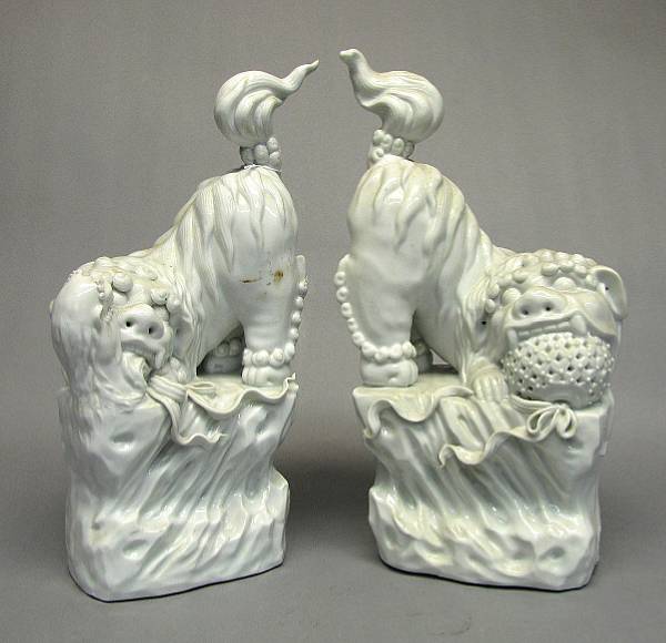 Appraisal: A pair of Dehua style fu lions th Century The