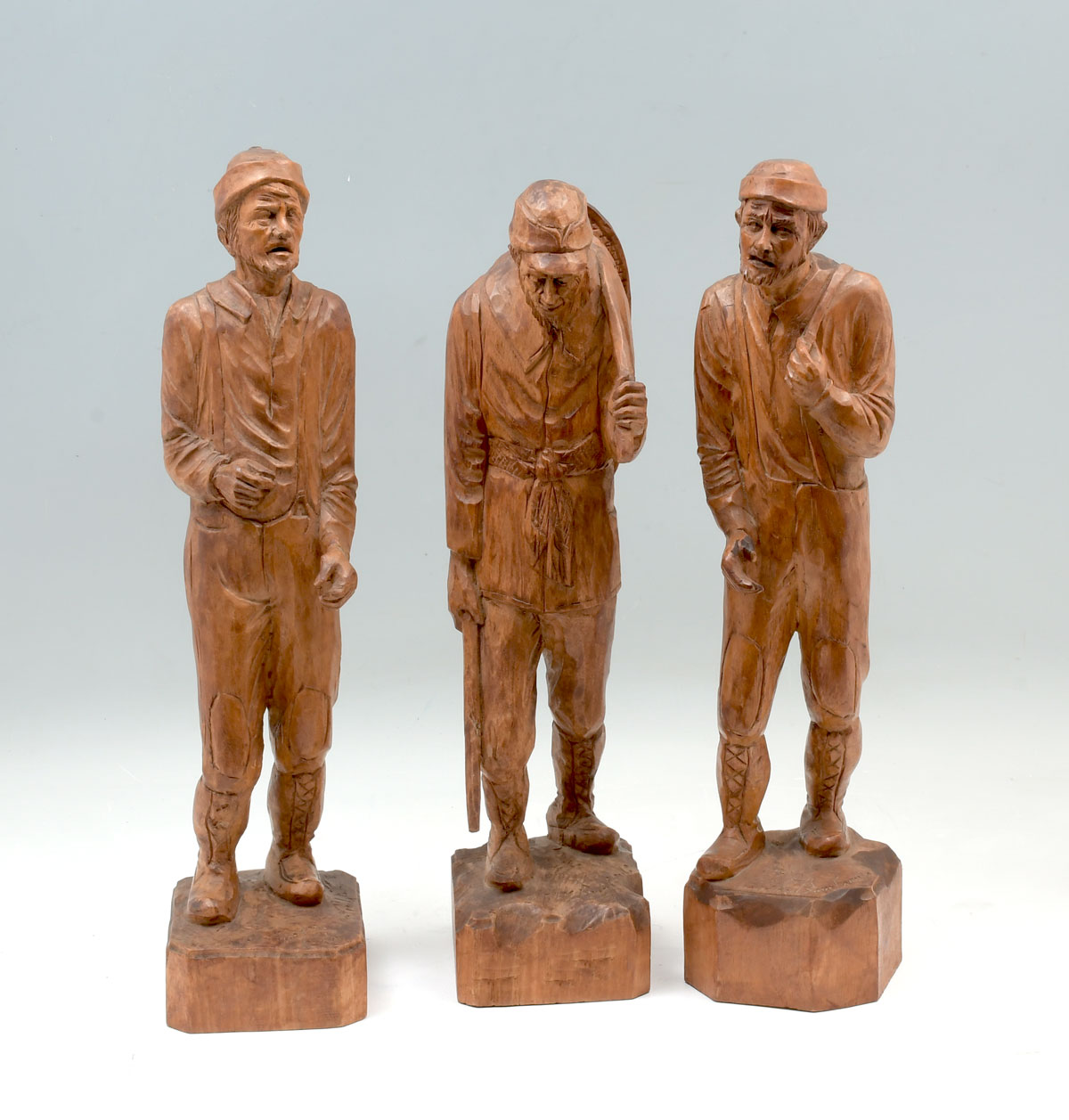 Appraisal: BOURGAULT Andre Canadian - Three Wood Carvings of Working Outdoorsman