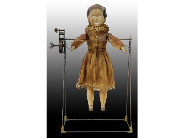 Appraisal: German Doll on Swing Toy Description Wind-up Not working Composition