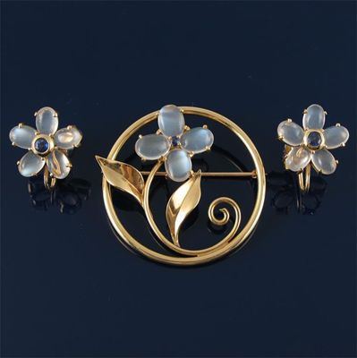 Appraisal: A floral brooch with oval shaped moonstones and a sapphire