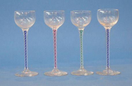 Appraisal: A HARLEQUIN SET OF FOUR LIQUEUR GLASSES with shallow bowls