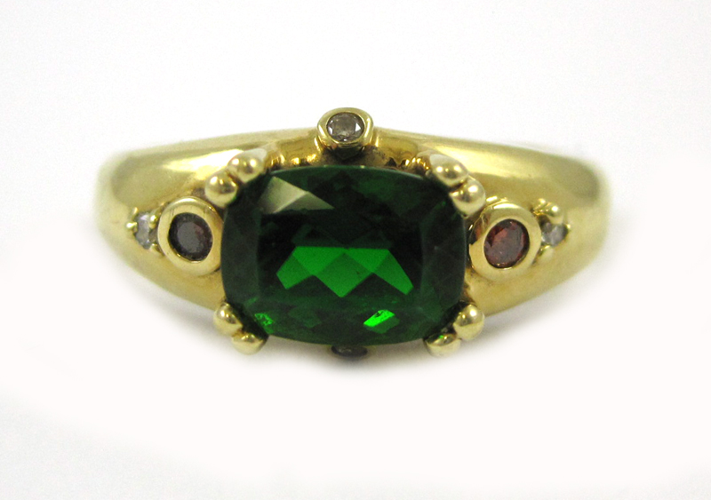 Appraisal: SYNTHETIC EMERALD AND EIGHTEEN KARAT GOLD RING with four round-cut