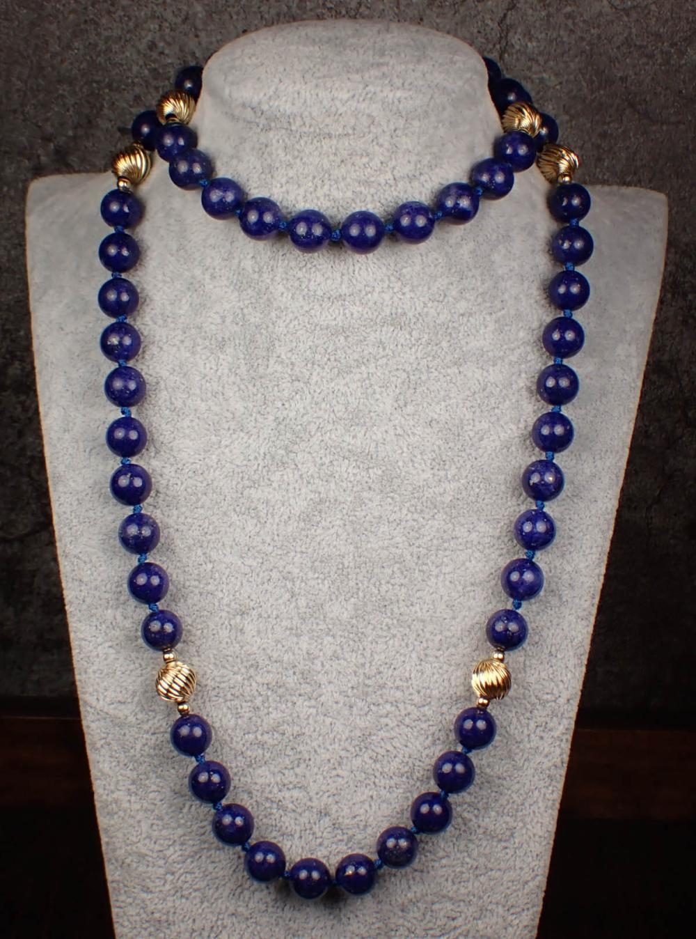 Appraisal: LAPIS LAZULI AND FOURTEEN KARAT GOLD BEAD NECKLACE hand-knotted strand