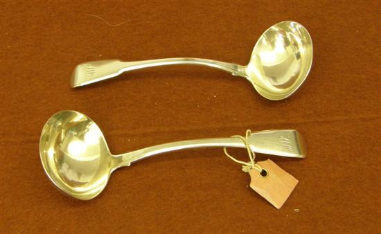 Appraisal: A pair of George III silver sauce ladles London oz