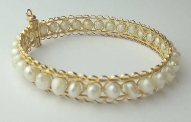 Appraisal: A gold and freshwater cultured pearl bangle probably Middle Eastern