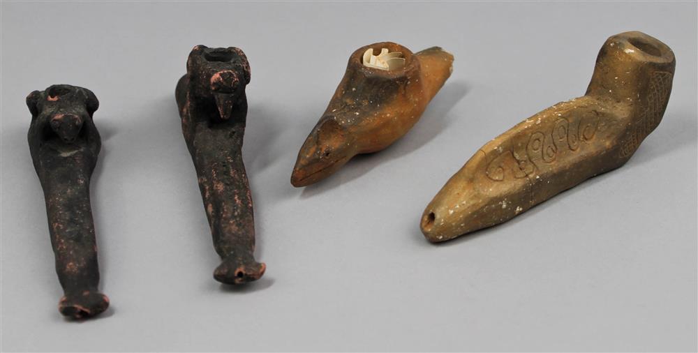 Appraisal: FOUR POTTERY EFFIGY PIPES th C reproductions two animal effigy