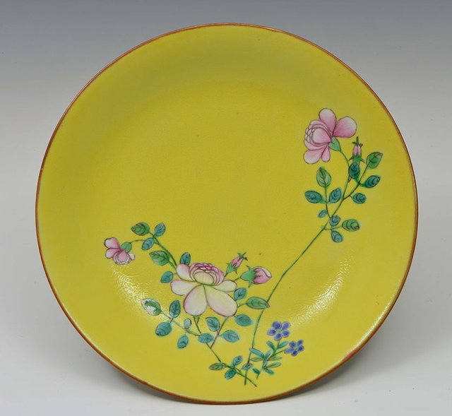 Appraisal: A CHINESE YELLOW GROUND DISH with flowering blossom on a