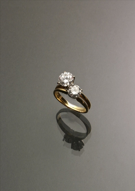 Appraisal: -Karat Yellow and White-Gold Twin-Diamond Dinner Ring The four-prong Tiffany-type