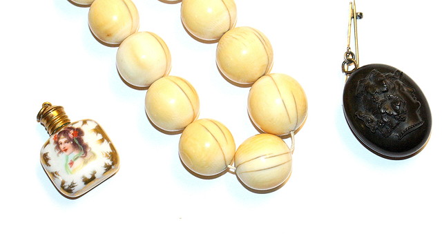 Appraisal: A VICTORIAN IVORY BEAD NECKLACE long a jet oval locket