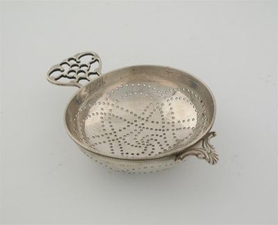 Appraisal: A th century Colonial strainer with a shell and scroll