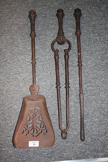 Appraisal: A SET OF THREE STEEL FIRE IRONS with cast scroll