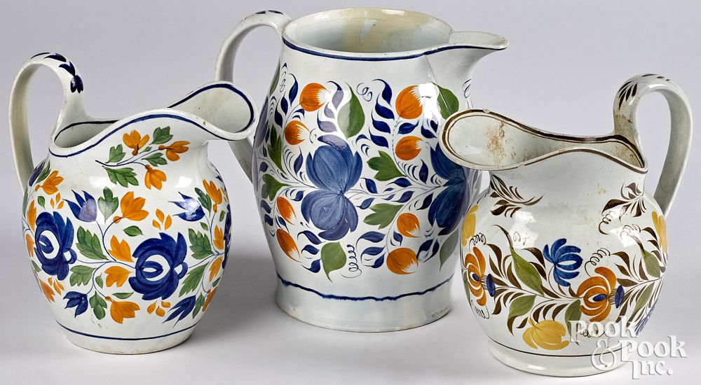 Appraisal: Three pearlware pitchers th c with floral dec Three pearlware