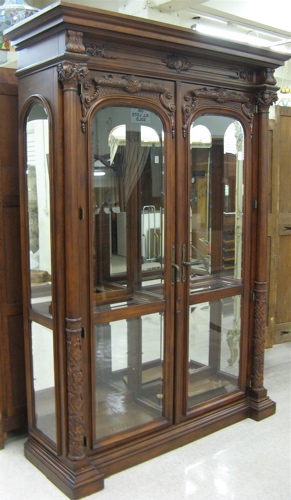 Appraisal: LARGE CARVED MAHOGANY AND BEVELED GLASS DISPLAY CABINET Renaissance style