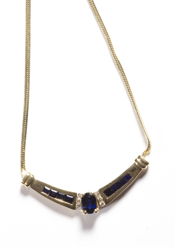 Appraisal: SAPPHIRE DIAMOND AND FOURTEEN KARAT GOLD NECKLACE with a V-shaped