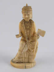 Appraisal: A carved ivory figure of a deity wearing a garland