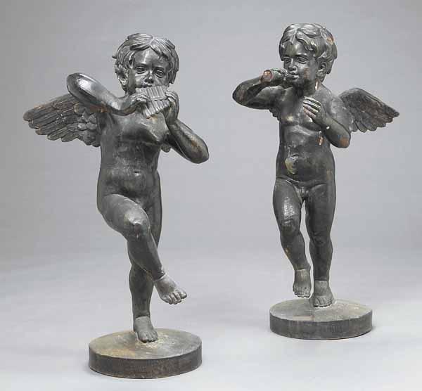 Appraisal: A Pair of Antique Cast Iron Winged Putti each musician