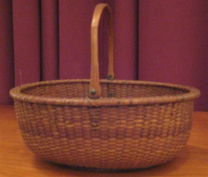 Appraisal: Nantucket lighthouse basket with swing handle early th century Oval