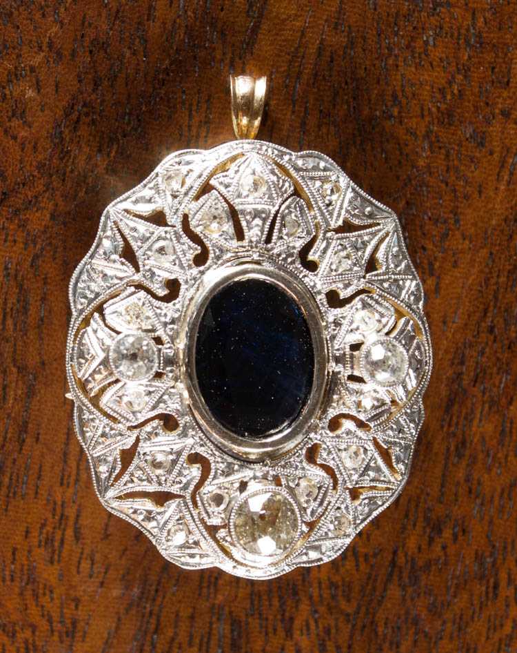 Appraisal: SAPPHIRE PLATINUM AND YELLOW GOLD PENDANT with three bezel set