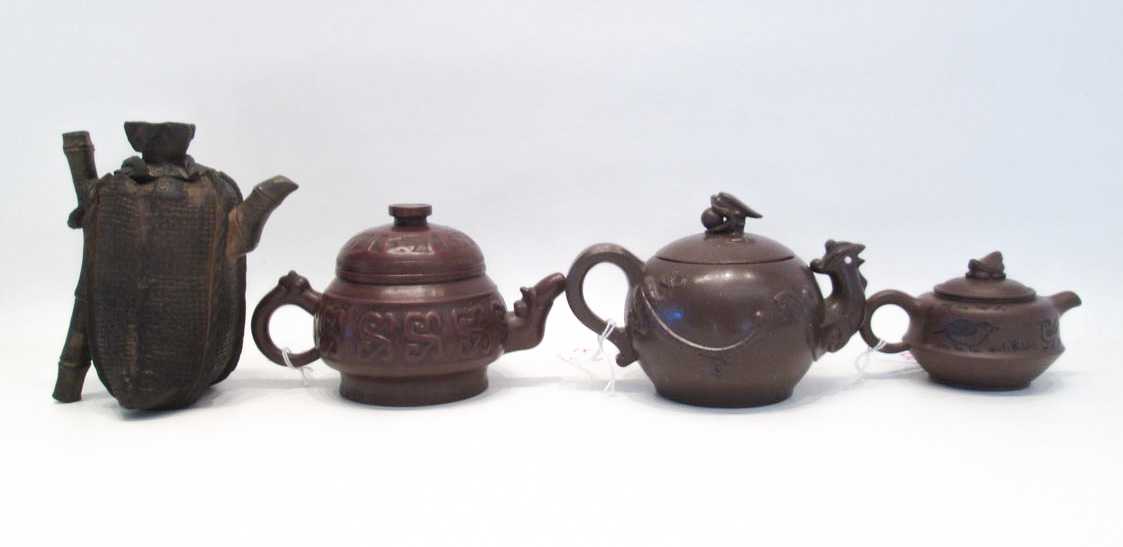 Appraisal: FOUR CHINESE EARTHENWARE TEAPOTS the first depicting a burlap sack