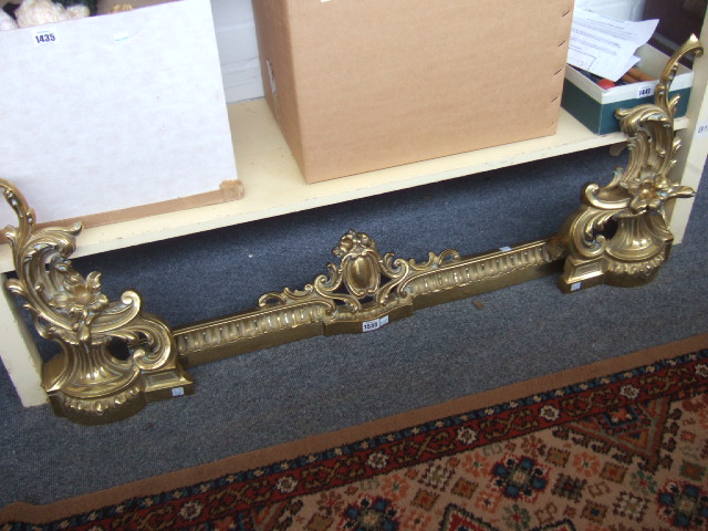 Appraisal: A brass adjustable fire fender th century of scrollwork rococo