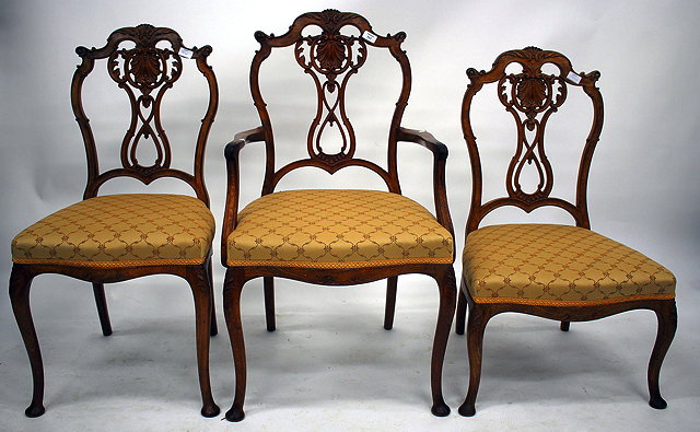 Appraisal: THREE MATCHING CONTINENTAL CARVED WALNUT CHAIRS each with pierced shell