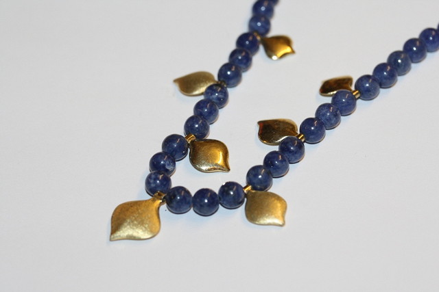 Appraisal: A LAPIS LAZULI BEAD NECKLACE with silver gilt mounts and