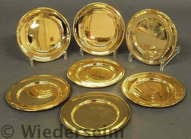 Appraisal: Seven sterling silver with gold wash butter plates diam troy