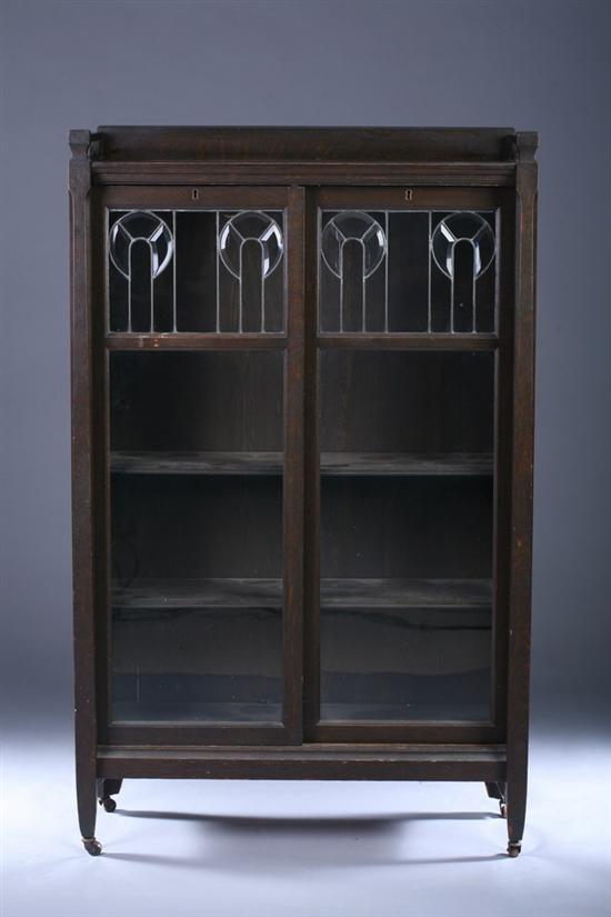 Appraisal: ART NOUVEAU OAK BOOKCASE CABINET early th century Leaded-glass back