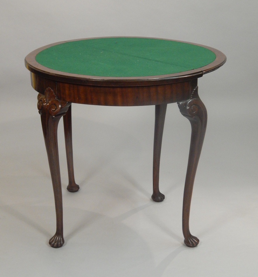 Appraisal: A thC mahogany demi-lune card table with a carved edge