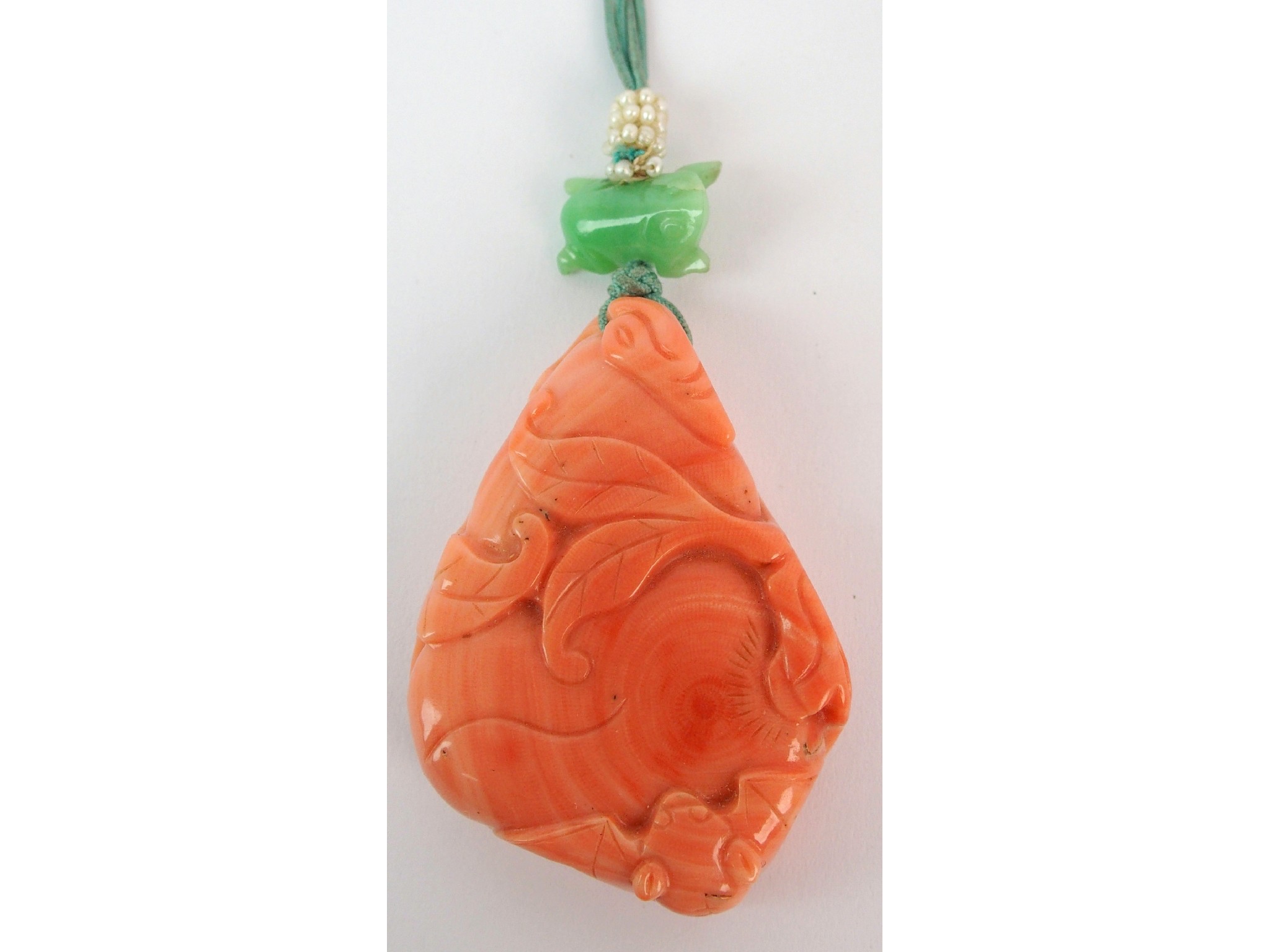 Appraisal: A Chinese hardstone pendantcarved as a peach branch with a