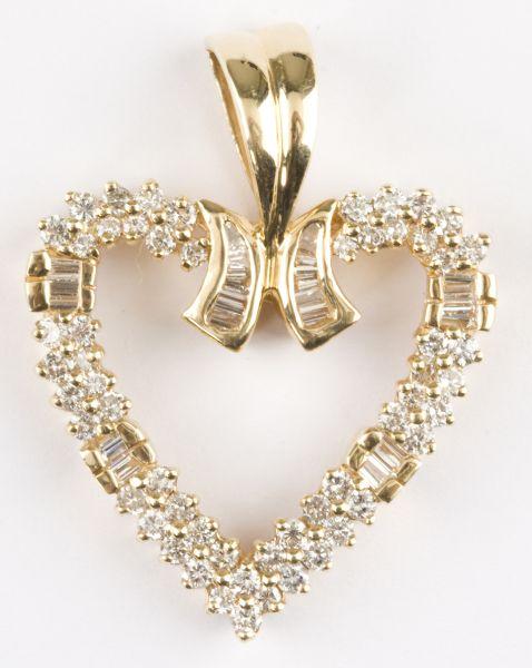 Appraisal: KT Heart Pendant containing round brilliant cut diamonds and baguette