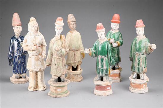 Appraisal: SEVEN POTTERY FIGURES Six Asian figures of robed men with