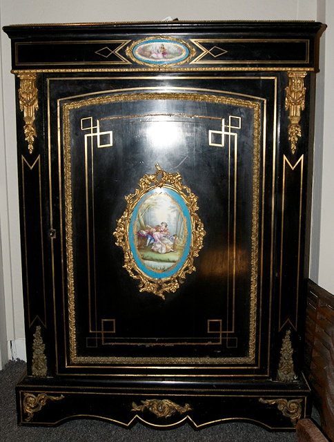 Appraisal: A late Victorian ebonised pier cabinetdecorated with metal mounts and