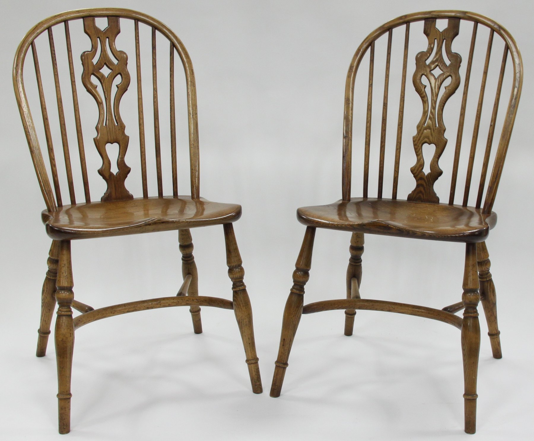 Appraisal: A pair of stick and pierced splat back chairs in