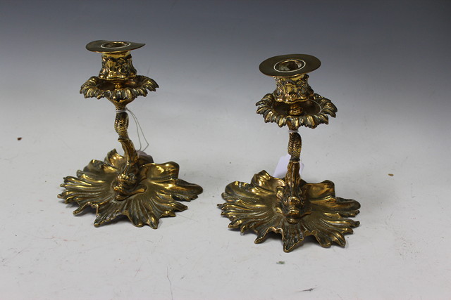 Appraisal: A PAIR OF OLD BRASS CANDLESTICKS the stems cast as