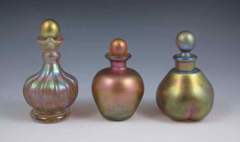 Appraisal: TIFFANY FAVRILE GLASS PERFUME BOTTLES Lobed globular and melon shaped