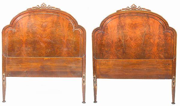 Appraisal: A pair of fruitwood twin headboards with four side rails