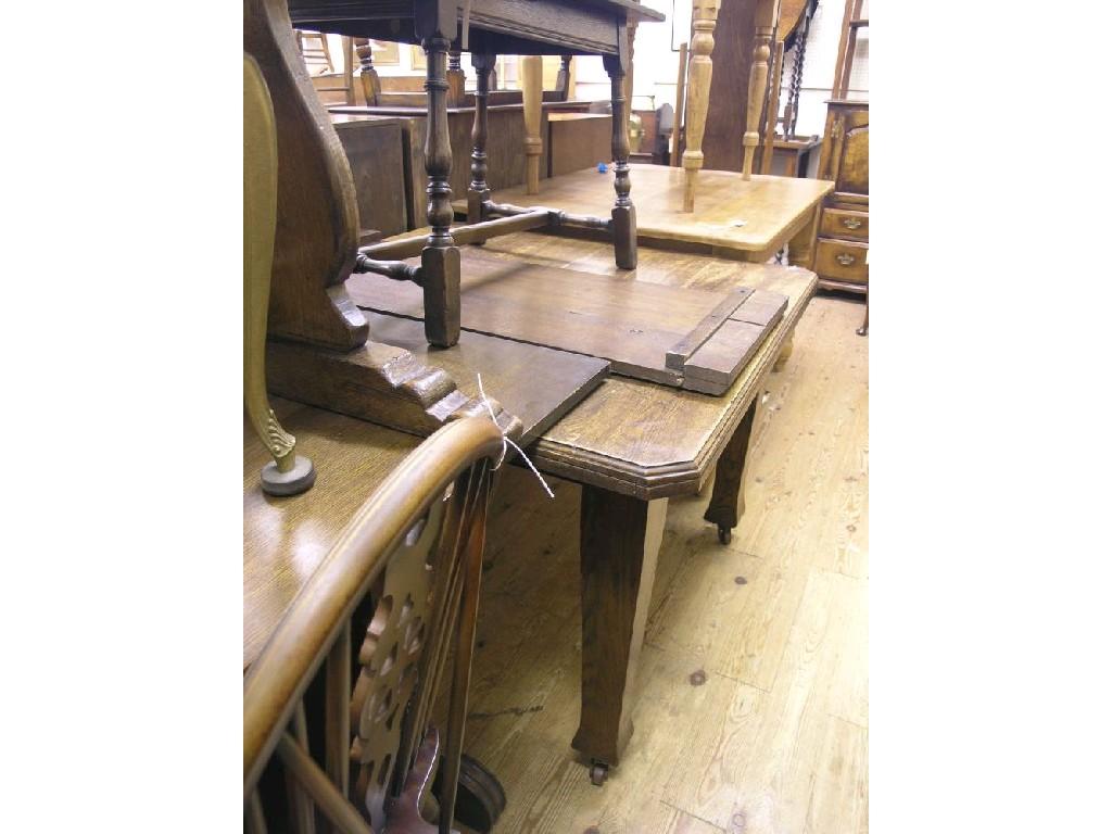 Appraisal: An early th century wind-action dining table with extra leaf