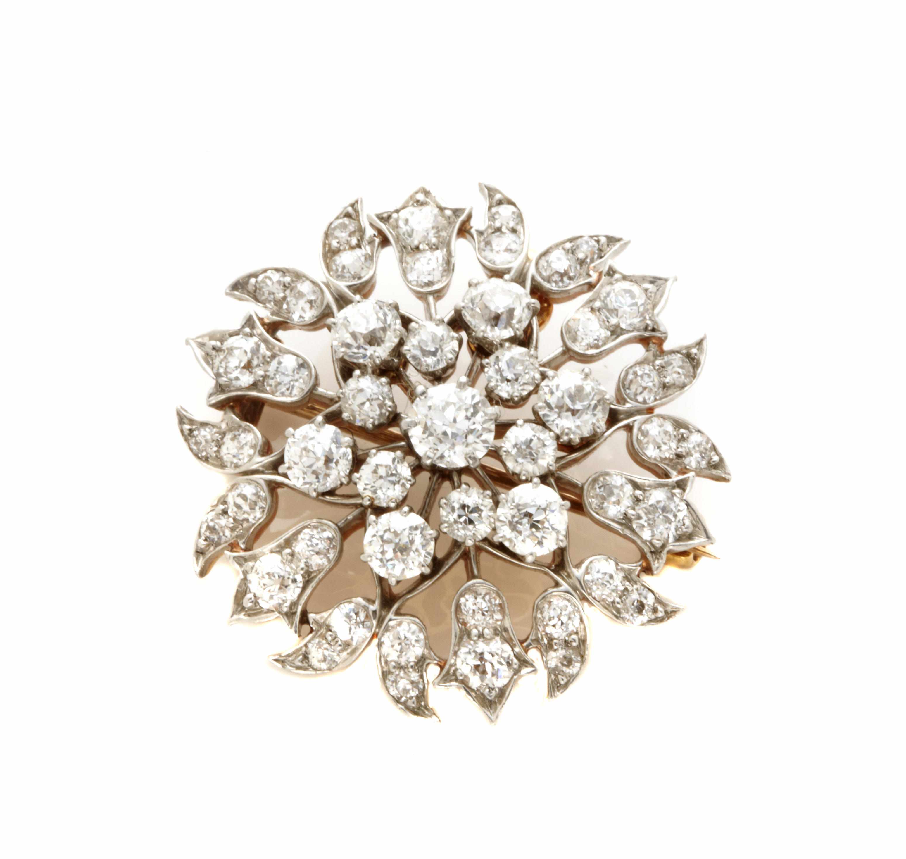 Appraisal: A diamond and platinum topped gold cluster pendant-brooch set throughout