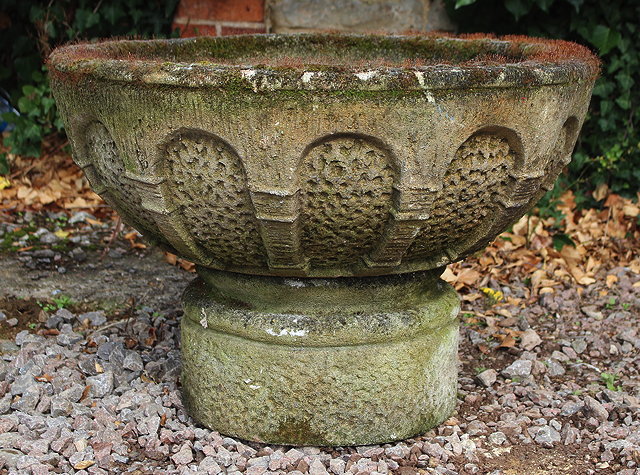 Appraisal: A LARGE COMPOSITE STONE ROMANESQUE CIRCULAR BOWL standing on a