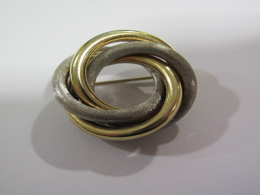 Appraisal: ct bicolour gold brooch in four entwined circular tubes in