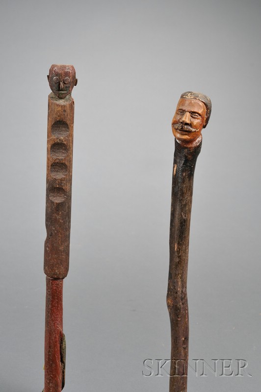 Appraisal: Two Carved and Painted Walking Sticks with Head Finials America