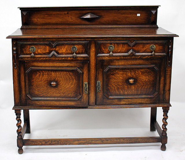 Appraisal: AN OAK SIDEBOARD together with a floor standing corner cupboard