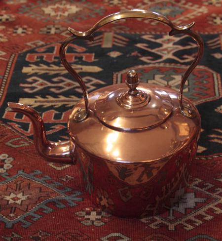 Appraisal: An early th century large copper kettle with double c-scroll