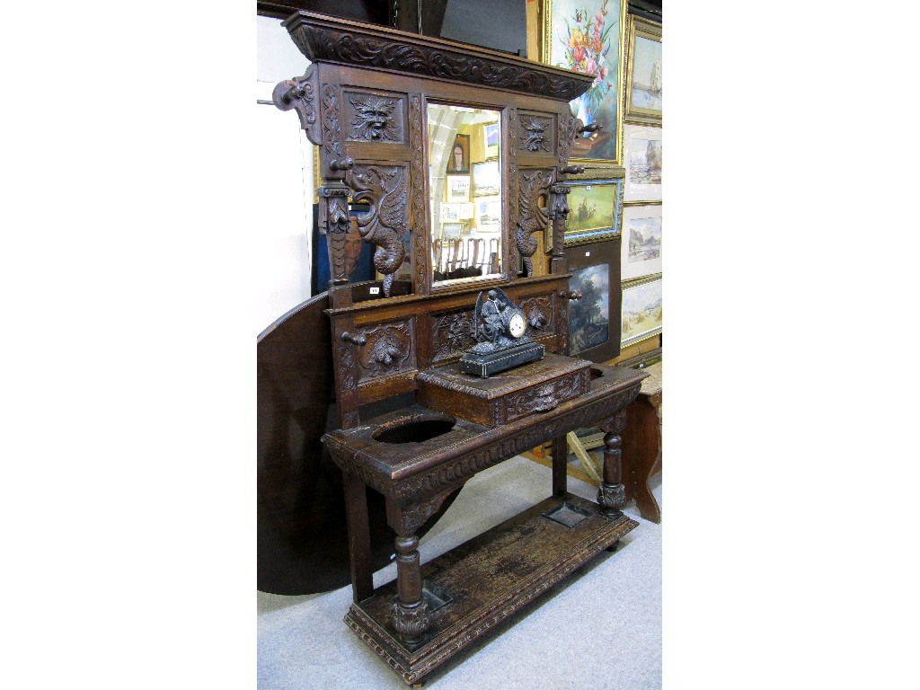 Appraisal: Profusely carved oak mirror back hallstand