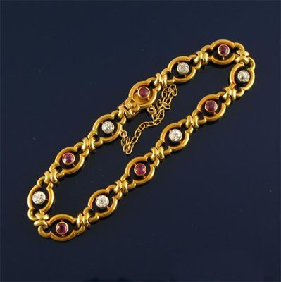 Appraisal: A pretty ruby and diamond set gold bracelet each shaped