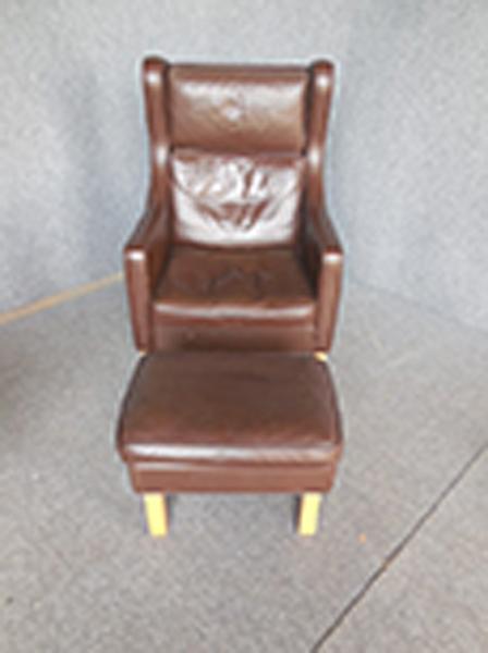 Appraisal: DANISH BROWN LEATHER ARMCHAIR AND FOOTSTOOL